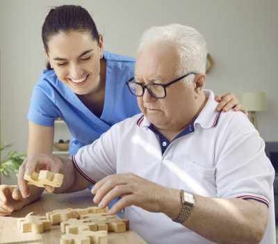 Medical staff playing with elderly man